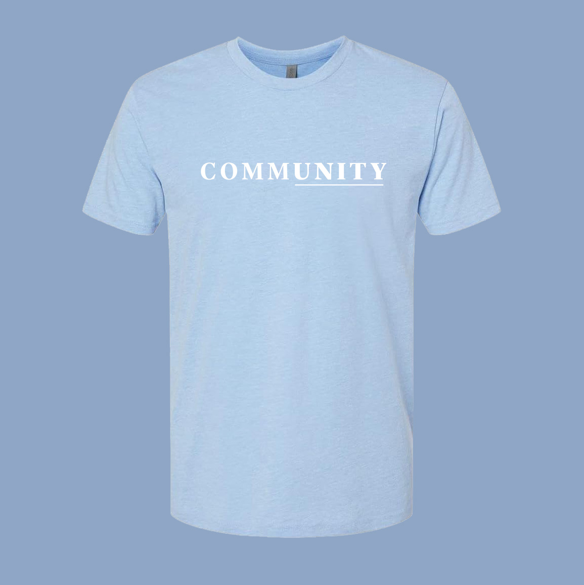 Baby blue heather t-shirt with the word community in white. a line is beneath the end of the word, bringing the word "unity" out of the shirt